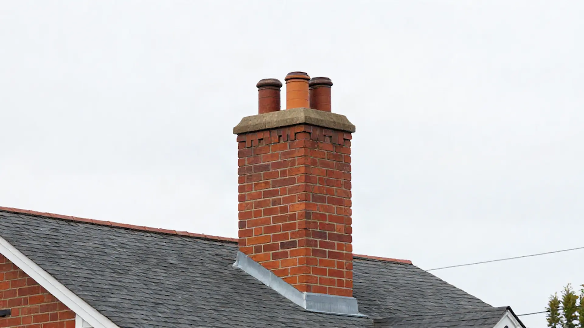 Brick chimney on a home served by Plumb Line Chimney Sweeps in Philadelphia, PA